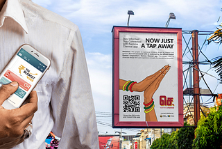 A Namma Chennai app user shows the app’s homepage on their phone with a billboard in the background, encouraging citizens to download the app.