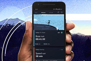 An image of a runner holding Byrd running app showing their upcoming runs. A mountain is in the background.