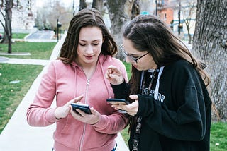 Two women looking at their smartphones