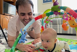 John and his son doing tummy time