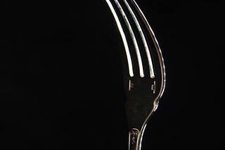 A fork is being used a visual prompt for improved conversation skills