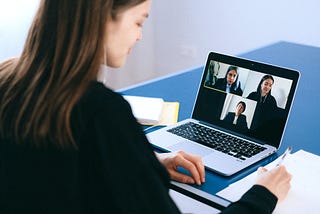 professional individual in an interpreting meeting on a laptop