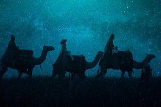 A picture of the three magi on camels under a night sky