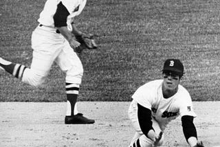 Baseball players fielding a hit.