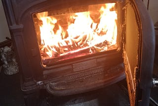 A fireplace stove burns a fire.