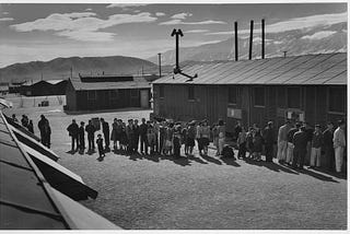 Ansel Adams photograph of the mess hall lunch line at the Manzanar Relocation Center, California.