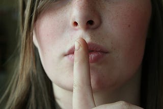 A girl with a finger on her lips