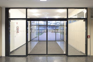 How do automatic sliding doors enhance the security of buildings?