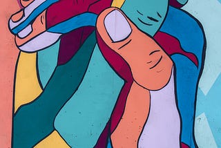 Image of a mosaic of colourful hands holding in unity