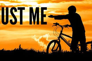 Color photo of a gorgeous sunset, a boy and girl with their bicycles.