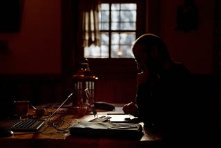 A man sits alone at a table for five