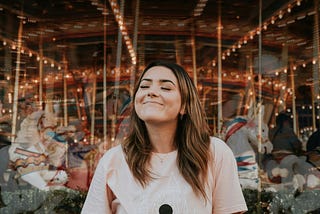 Woman in white crew neck t-shirt smiling.