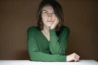 A woman wearing a green long sleeved shirt