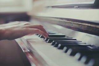 Image of hands on a piano keyboard
