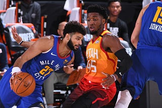 Two basketball players (Jamal Murray (left) and Donovan Mitchell (right)) facing off