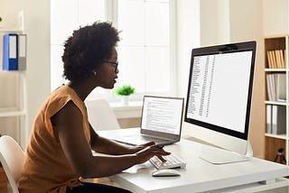 Black woman doing research on a computer