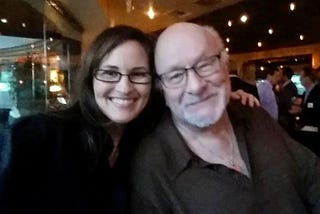 woman and older man, smiling. Clearly a strong friendship.