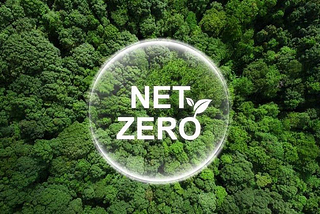 Aerial view of a dense green forest with a transparent circle overlay containing the text “NET ZERO” and a small leaf icon, symbolizing environmental targets for carbon neutrality.