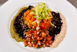 Butternut squash burrito bowl on a white plate