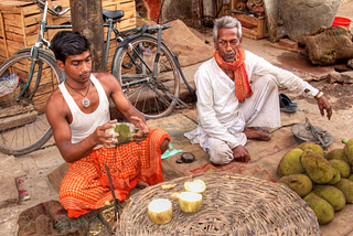 Street hawkers in India sitting on the ground selling their wares