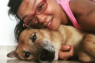 asian girl red glasses with brown mongrel dog