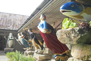 The photograph shows some of the unique and highly decoratively painted carved figureheads of fish, men and women, which were once attached to the bows of sailing ships, and which are now housed in the Valhalla collection situated within Tresco Abbey Garden, Scilly Isles.