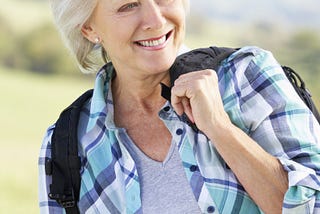 Happy senior woman enjoying a country walk