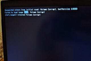 Photo of my laptop failing to boot, “failed to load image”, “Volume Corrupt”