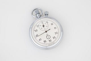 an analogue stopwatch with a white face
