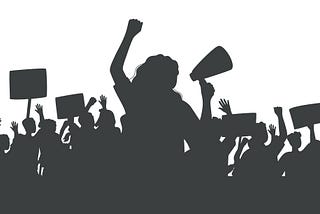 Silhouette of protesting crowd of people with raised hands and banners. Person with loudspeaker at center.