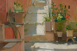 Peachy, pink walls enclose a patio of stone steps, a cistern, and potted plants.