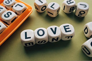 A Boggle game with the letter blocks spelling out “LOVE.”