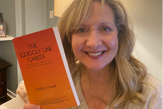 Angela with a copy of her book, ‘The Squiggly Line Career’