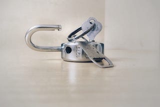 Image of a key and an open padlock.