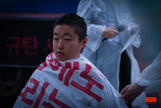 A South Korean woman shaving her hair in a protest