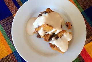 Plated bread pudding with topping.