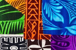 Pieces of overlapping Samoan fabric in bright colors and graphic stenciled designs.