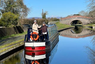 Photo of crew of hire narrowboat moored on canal. 

Photo use by permission and courtesy of Time2Geaux.