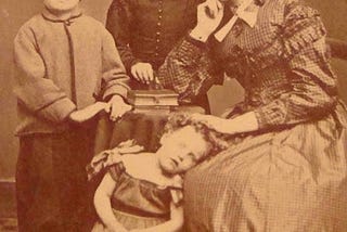 A Victorian family photo. One of the children is deseased