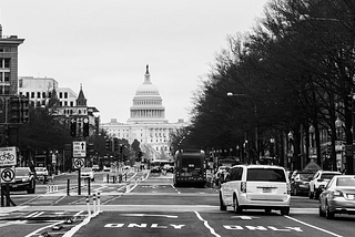 DC street traffic. Capitol building in the background