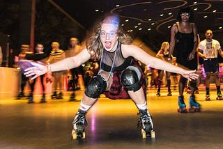 girl on roller skates in a rink. she looks joyful