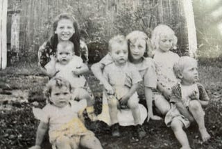 Old black and white photo from the 1940s showing Appalachian children posing together.