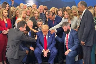 Trump surrounded by praying sycophants