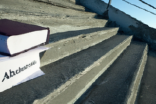 A stair with a book on one of the steps