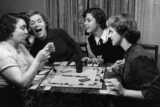 A photograph taken in 1951 of a group of women playing Monopoly.