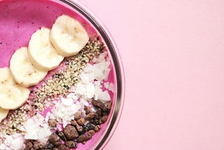 Pink smoothie with some toppings on top.