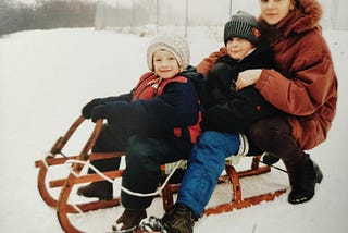 My mom, me and my brother sledding