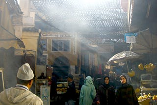 Medina souk with sunlight streaming through the smoke