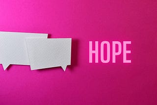 Bright colorful paper with two blank thought bubbles and the word “hope”