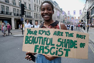 Protestor at an anti-fascism demonstration in London holds up a sign: Your eyes are the most beautiful shade of fascist